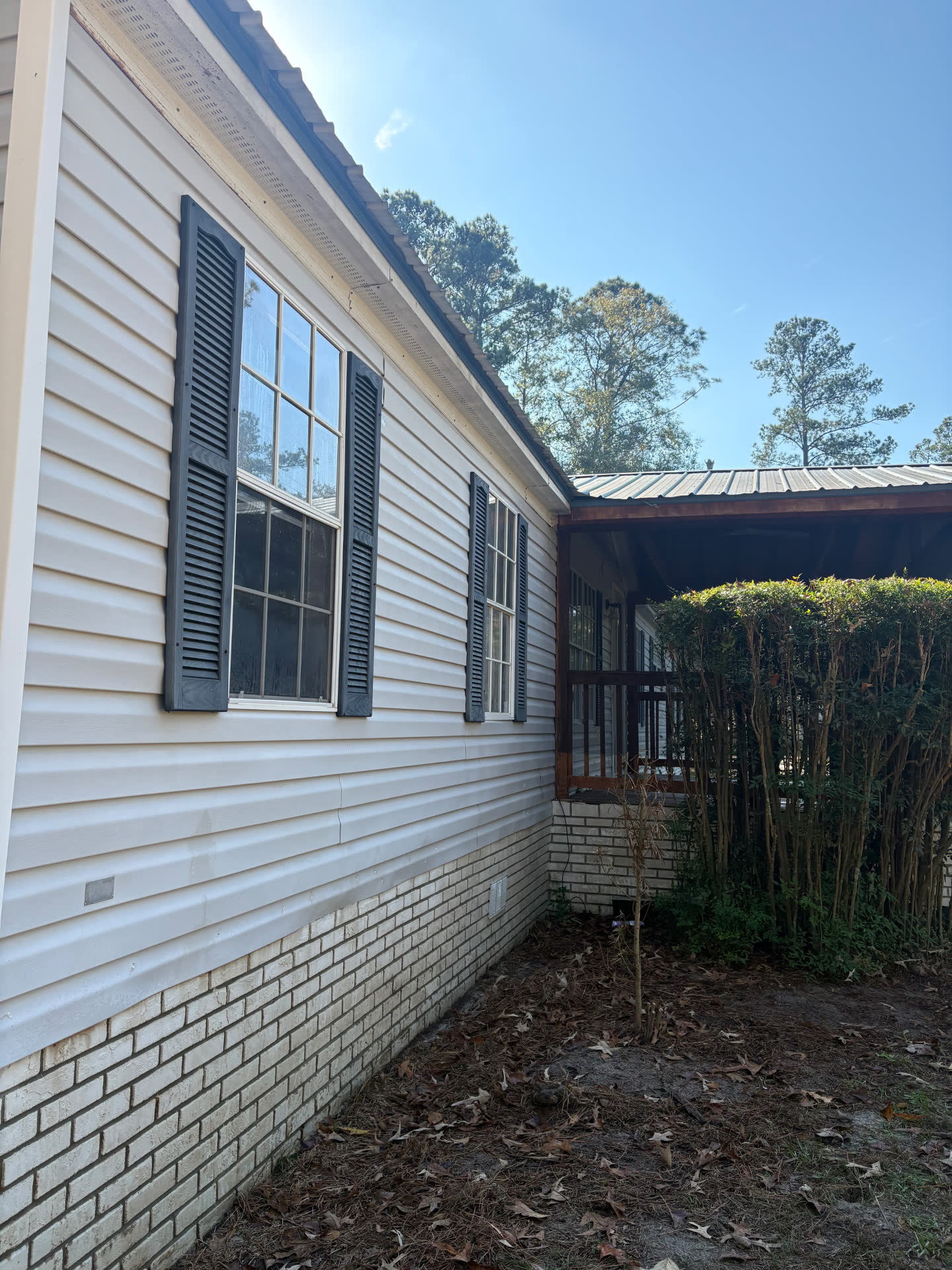 The same vinyl siding and brick clean and bright after soft washing