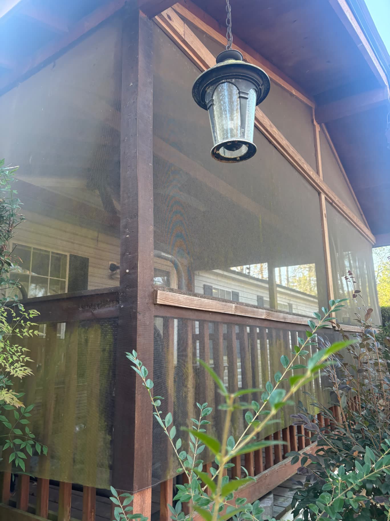 Wood screened porch exterior with clean screens and railings